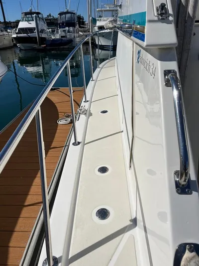  Yacht Photos Pics 1993 Radovich 34 boat deck with railing, docked at marina.
