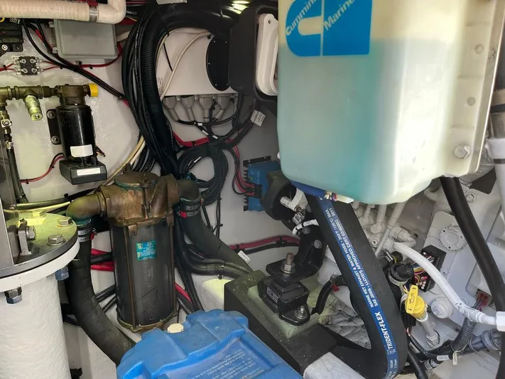  Yacht Photos Pics Engine room of a 1993 Radovich 34 boat, showcasing various mechanical components and wiring.