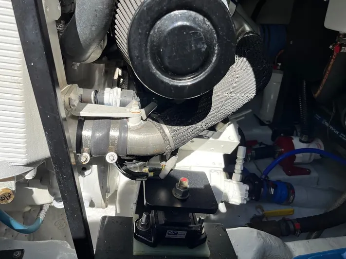  Yacht Photos Pics Engine compartment of a 1993 Radovich 34 boat, showcasing mechanical components and hoses.