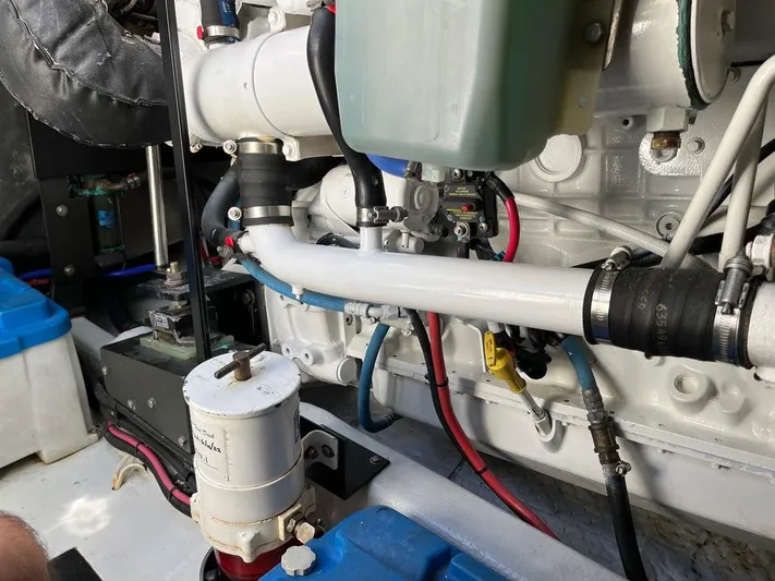  Yacht Photos Pics Engine compartment of a 1993 Radovich 34, showcasing pipes, hoses, and mechanical components.