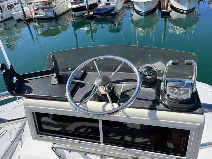  Yacht Photos Pics Steering console of a 1993 Radovich 34 boat docked at a marina.