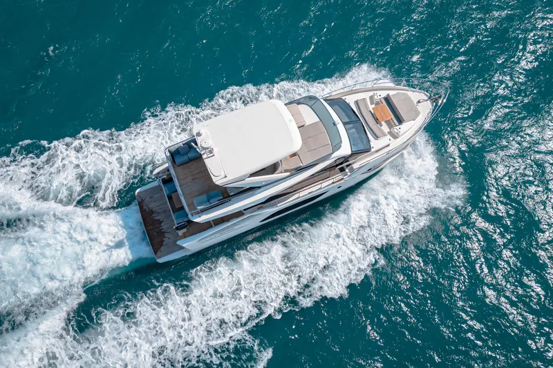  Yacht Photos Pics Aerial view of 2022 Absolute 56 FLY yacht cruising on blue ocean waters.