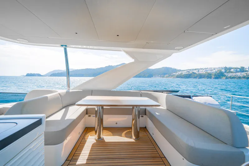  Yacht Photos Pics Luxurious 2022 Absolute 56 FLY yacht deck with seating, ocean view, and modern design.