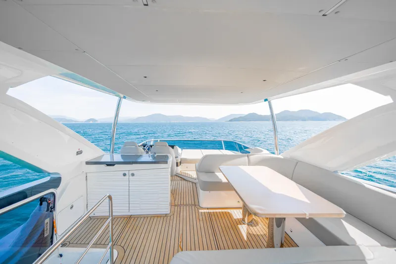 Yacht Photos Pics Luxurious 2022 Absolute 56 FLY yacht interior with ocean view and elegant seating area.