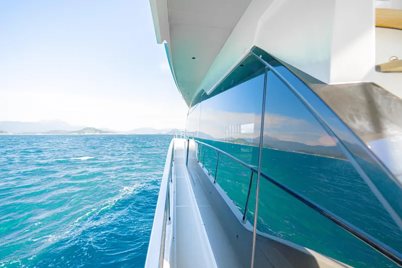  Yacht Photos Pics Side view of 2022 Absolute 56 FLY yacht cruising on open sea.
