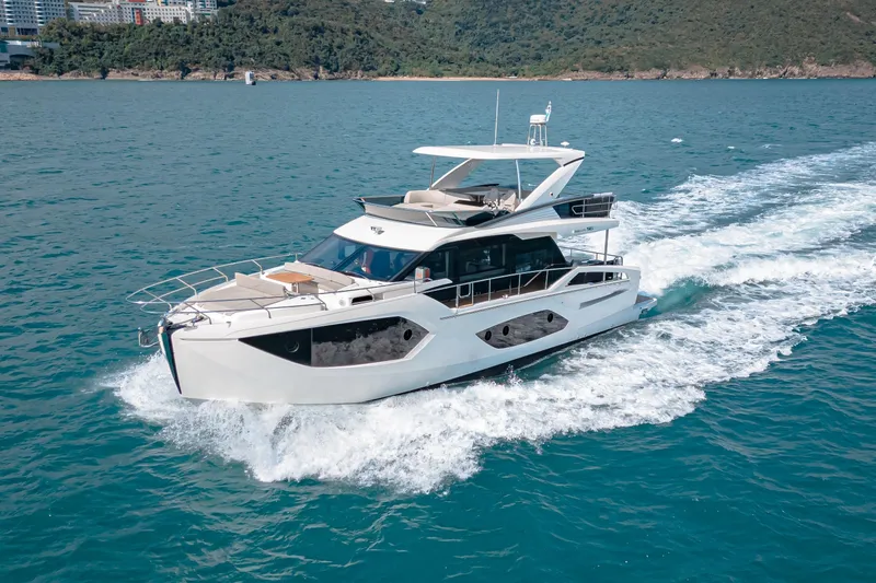  Yacht Photos Pics Luxury yacht Absolute 56 FLY 2022 cruising on blue ocean waters.