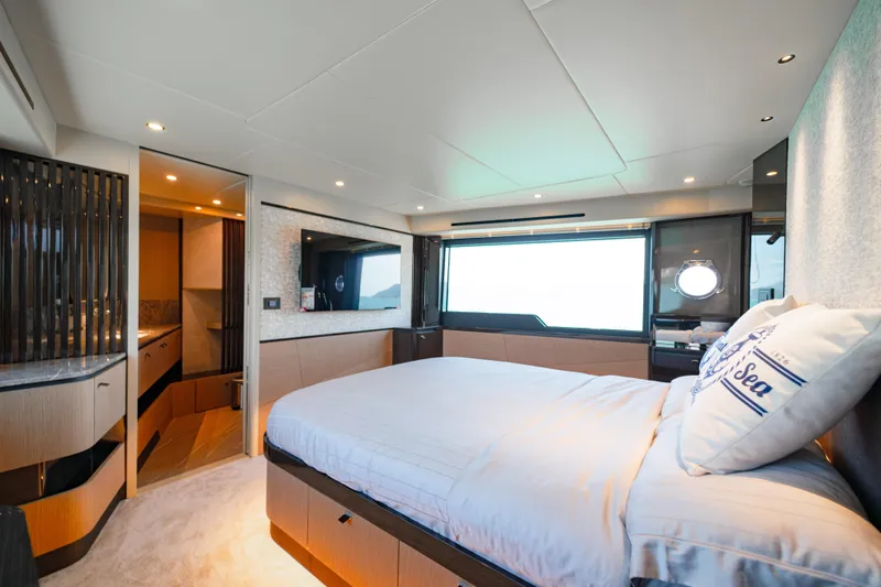  Yacht Photos Pics Luxurious bedroom interior of 2022 Absolute 56 FLY yacht with modern design and large window.
