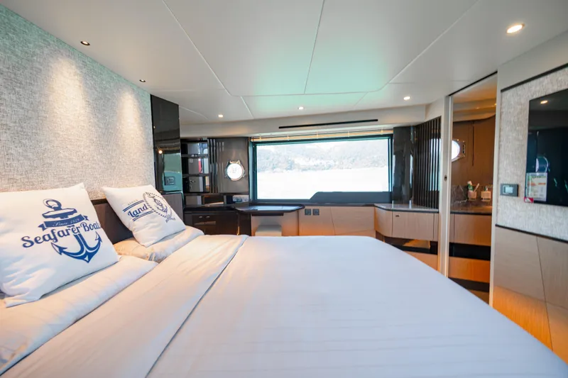  Yacht Photos Pics Luxurious bedroom interior of 2022 Absolute 56 FLY yacht with modern design and scenic window view.