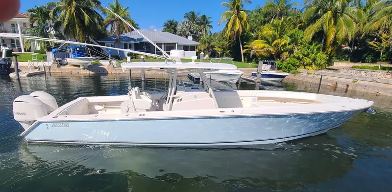 Da Blue Eagle Yacht Photos Pics 2011 Jupiter 38 boat docked in a tropical setting with palm trees.