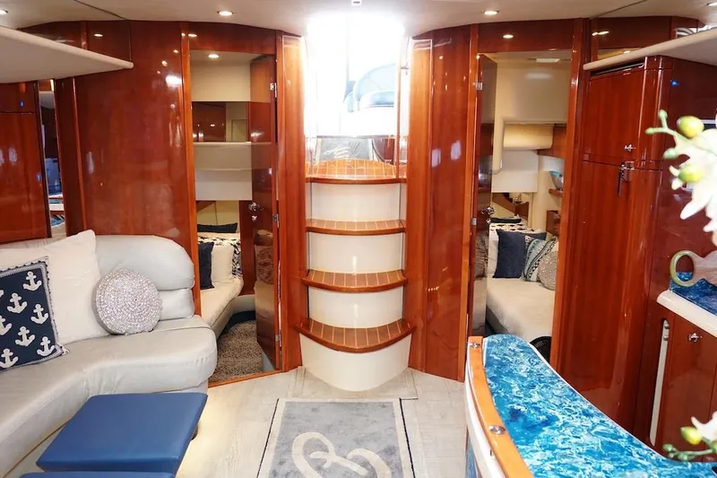  Yacht Photos Pics Luxurious interior of 2009 Fairline 52 Targa yacht with elegant wood finishes and cozy seating.