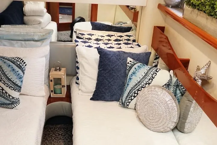  Yacht Photos Pics Cozy interior of 2009 Fairline 52 Targa yacht with decorative pillows and elegant bedding.