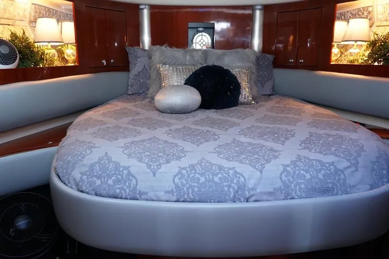  Yacht Photos Pics Luxurious bedroom interior of 2009 Fairline 52 Targa yacht with elegant bedding and decor.