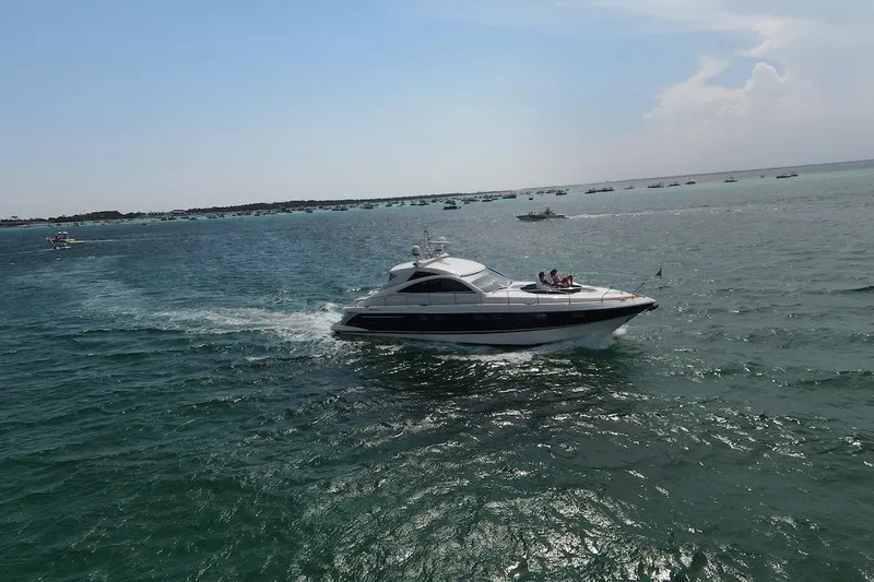  Yacht Photos Pics 2009 Fairline 52 Targa yacht cruising on open water under a clear sky.