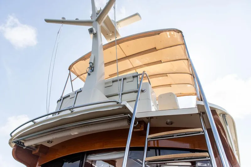 Paddy Wagon Yacht Photos Pics 2017 Hinckley Talaria 43 Flybridge yacht with ladder and canopy, viewed from below.