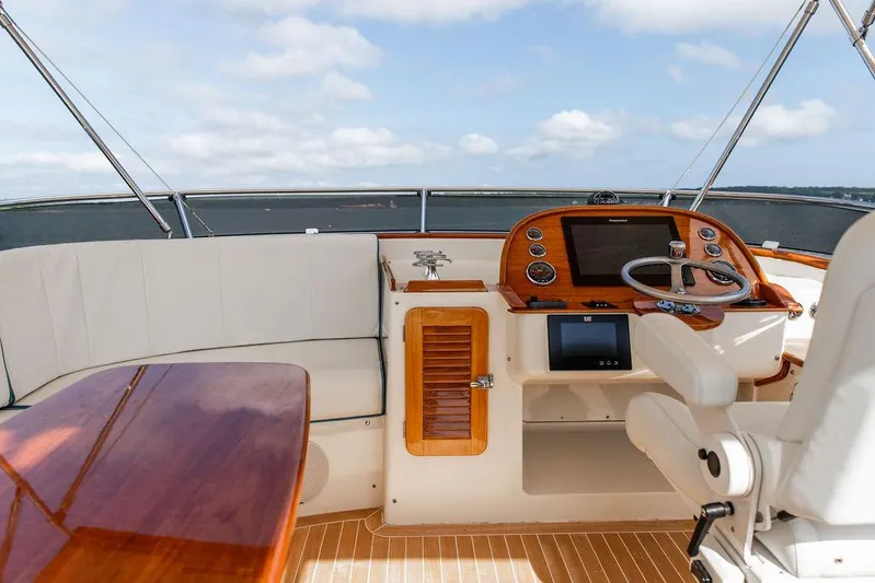 Paddy Wagon Yacht Photos Pics Flybridge of 2017 Hinckley Talaria 43, featuring elegant seating and advanced navigation controls.
