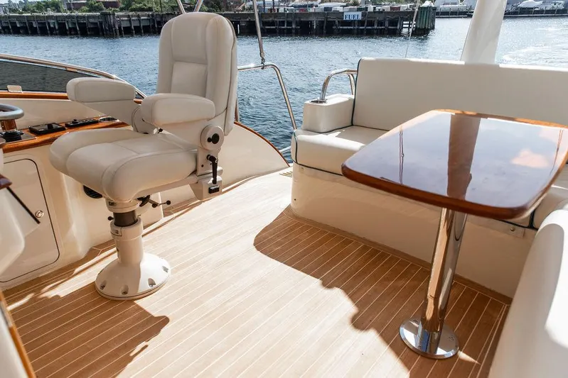 Paddy Wagon Yacht Photos Pics Luxurious 2017 Hinckley Talaria 43 Flybridge interior with elegant seating and polished wood table.