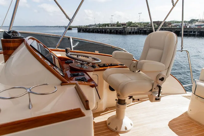 Paddy Wagon Yacht Photos Pics Luxurious helm of 2017 Hinckley Talaria 43 Flybridge yacht with leather captain's chair.