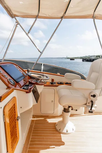 Paddy Wagon Yacht Photos Pics Flybridge helm of 2017 Hinckley Talaria 43, featuring luxurious seating and navigation controls.