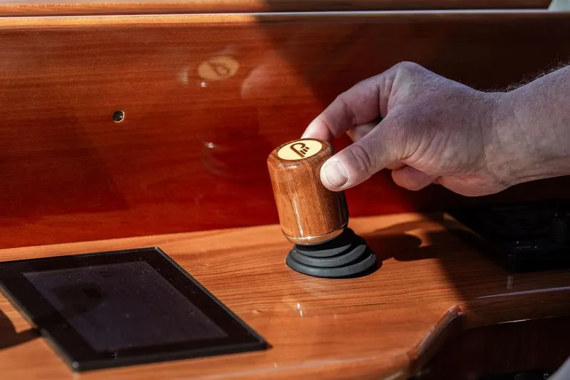 Paddy Wagon Yacht Photos Pics Hand operating joystick on 2017 Hinckley Talaria 43 Flybridge yacht's wooden dashboard.