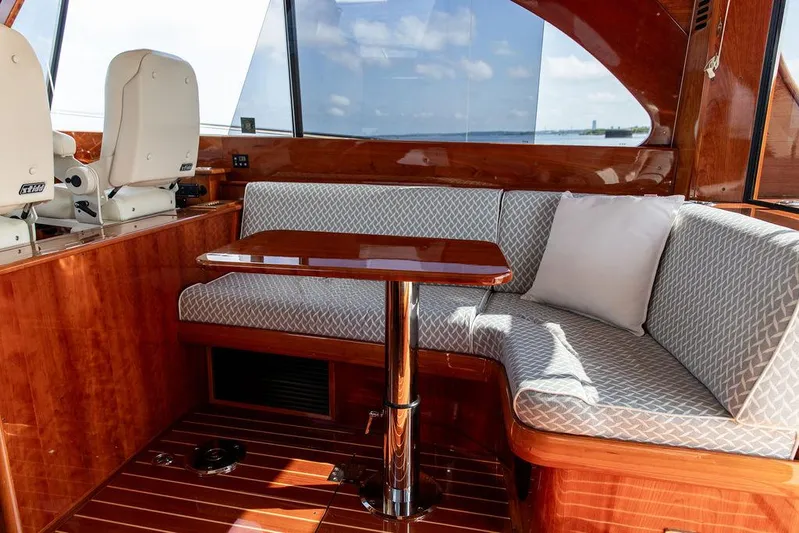 Paddy Wagon Yacht Photos Pics Luxurious interior of 2017 Hinckley Talaria 43 Flybridge with elegant seating and wooden finishes.