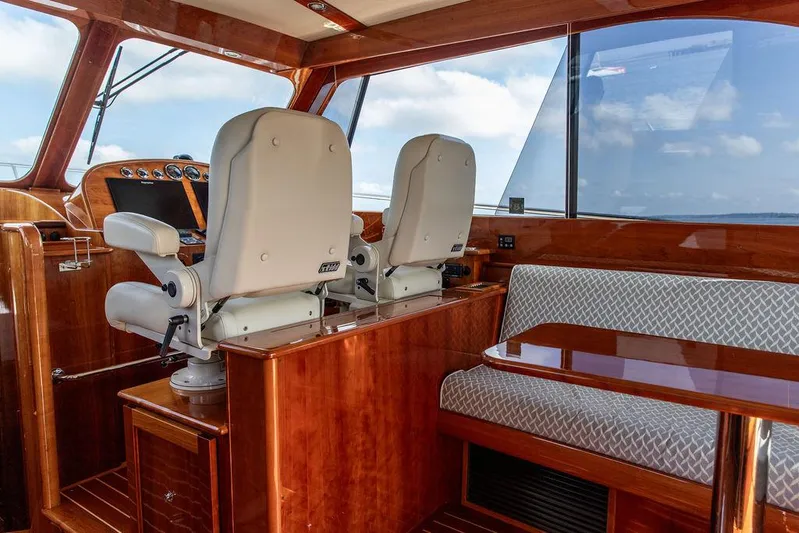 Paddy Wagon Yacht Photos Pics Interior of 2017 Hinckley Talaria 43 Flybridge with helm seats and seating area.