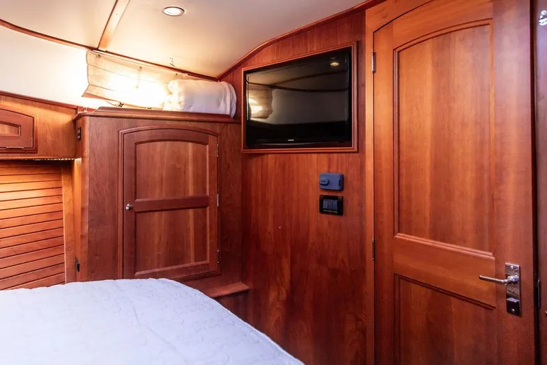 Paddy Wagon Yacht Photos Pics Luxurious wood interior of 2017 Hinckley Talaria 43 Flybridge yacht cabin with TV and storage.