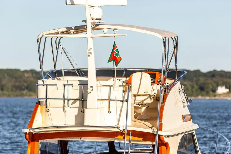 Paddy Wagon Yacht Photos Pics 2017 Hinckley Talaria 43 Flybridge yacht on calm water, showcasing elegant design and flybridge.