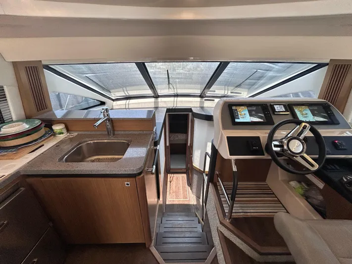 Here & Now 2017 Sea Ray 510 Fly @ Acapulco Yacht Photos Pics 2017 Sea Ray Fly 510 yacht interior with helm, sink, and stairs.