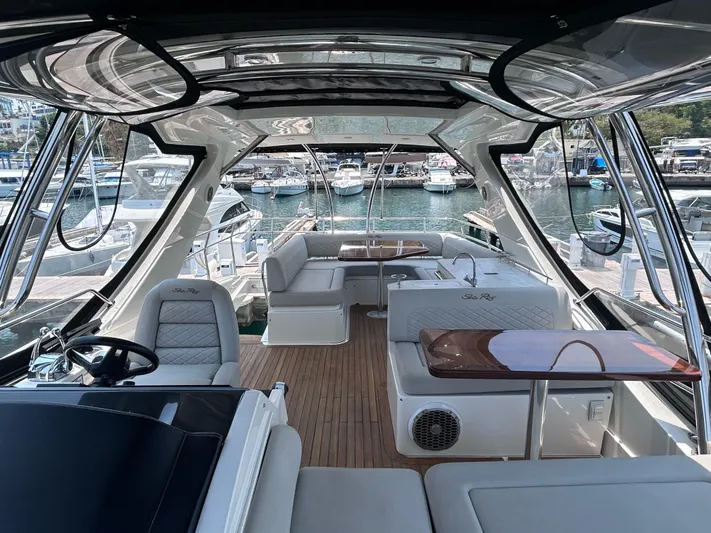 Here & Now 2017 Sea Ray 510 Fly @ Acapulco Yacht Photos Pics Interior view of 2017 Sea Ray Fly 510 yacht, featuring luxurious seating and marina backdrop.