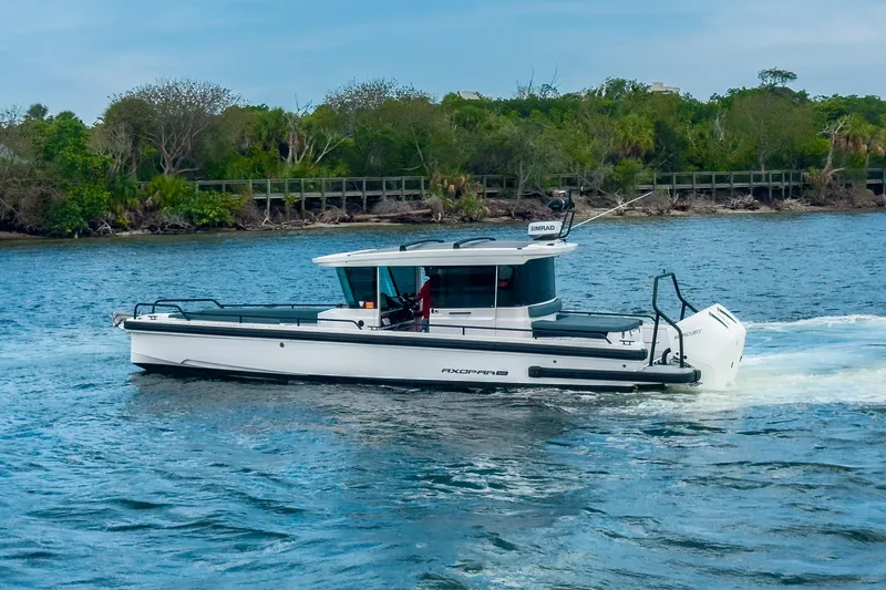  Yacht Photos Pics 2022 Axopar 28 Cabin BRABUS Trim boat cruising on a scenic waterway.