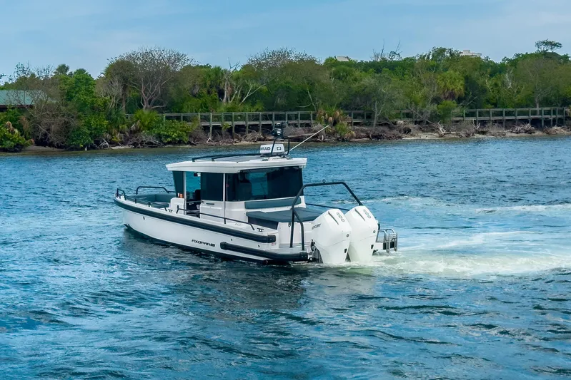  Yacht Photos Pics 2022 Axopar 28 Cabin BRABUS Trim cruising on a scenic waterway.