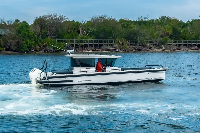  Yacht Photos Pics 2022 Axopar 28 Cabin BRABUS Trim cruising on a scenic waterway.