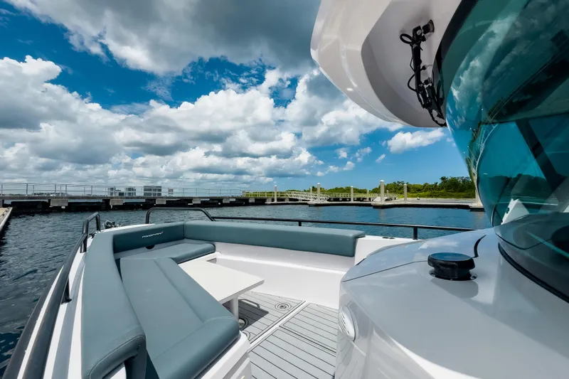  Yacht Photos Pics 2022 Axopar 28 Cabin BRABUS Trim boat with sleek seating, docked under a cloudy sky.