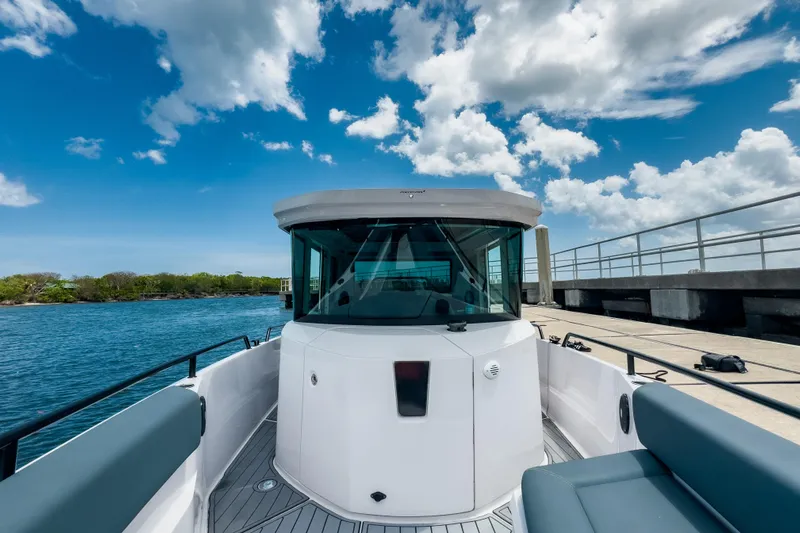  Yacht Photos Pics 2022 Axopar 28 Cabin BRABUS Trim boat docked under a blue sky.