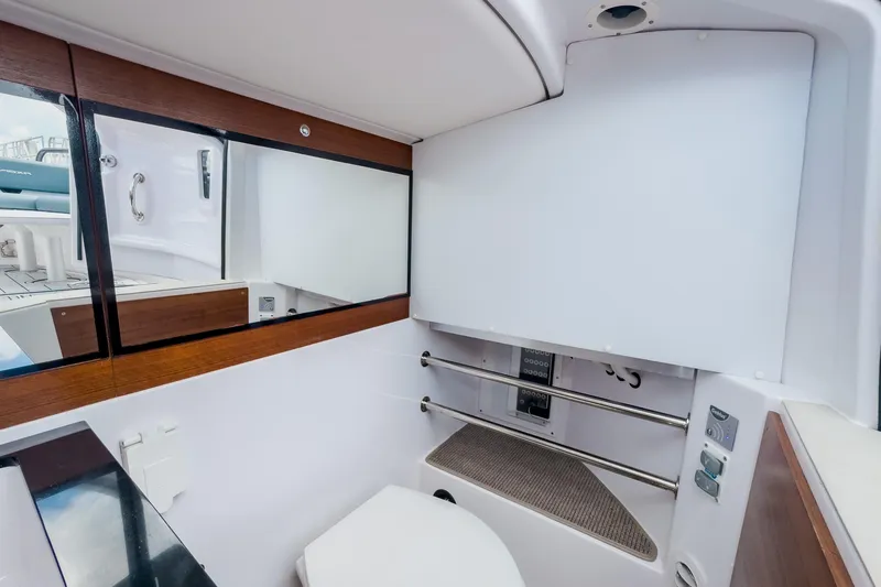  Yacht Photos Pics 2022 Axopar 28 Cabin BRABUS Trim interior bathroom with modern fixtures and wood accents.