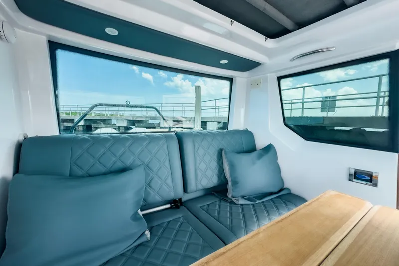 Yacht Photos Pics Luxurious interior of 2022 Axopar 28 Cabin BRABUS Trim with quilted seating and scenic windows.