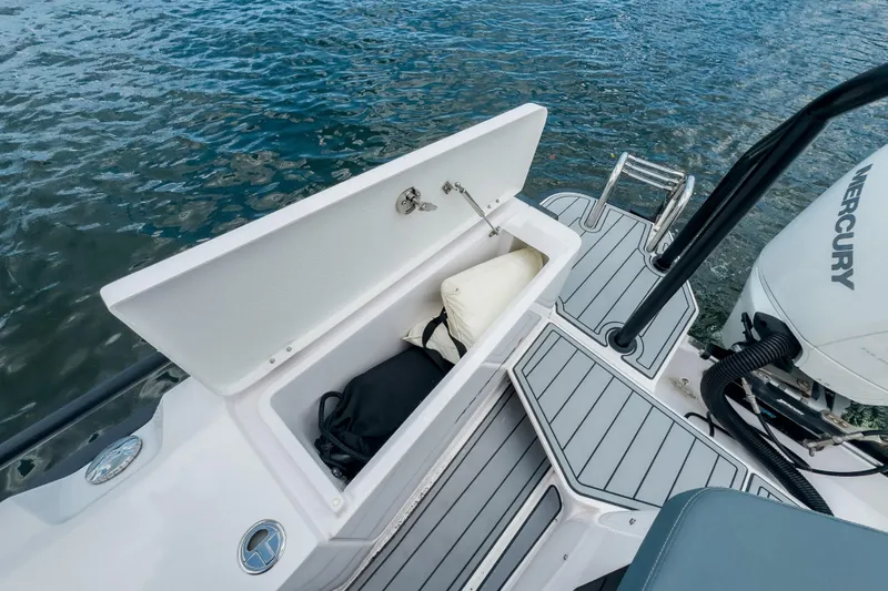  Yacht Photos Pics 2022 Axopar 28 Cabin BRABUS Trim boat with open storage compartment and Mercury engine.