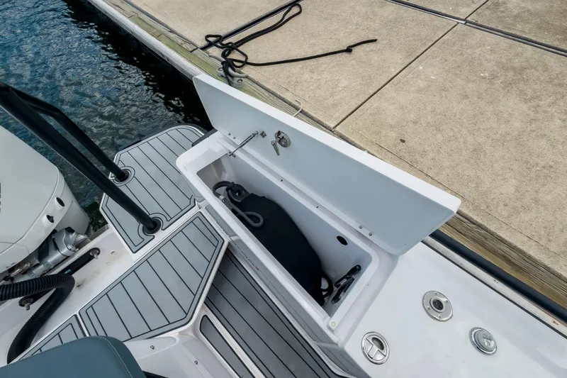  Yacht Photos Pics Axopar 28 Cabin BRABUS Trim 2022 boat storage compartment by the dock.