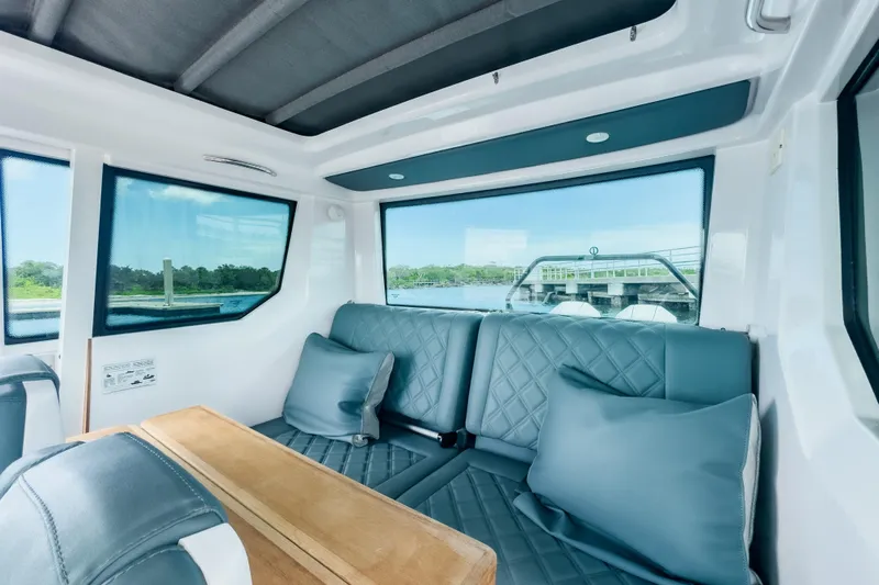  Yacht Photos Pics Interior of 2022 Axopar 28 Cabin BRABUS Trim with plush seating and scenic window views.