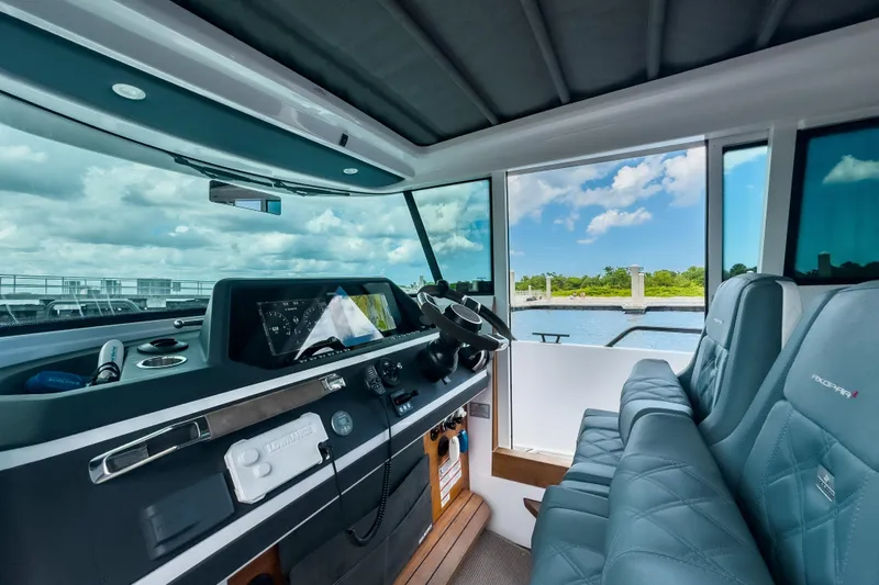  Yacht Photos Pics Interior of 2022 Axopar 28 Cabin BRABUS Trim, featuring modern dashboard and seating.