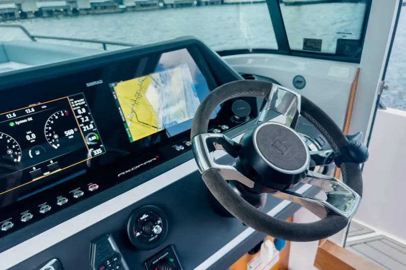  Yacht Photos Pics Steering wheel and dashboard of 2022 Axopar 28 Cabin BRABUS Trim boat.