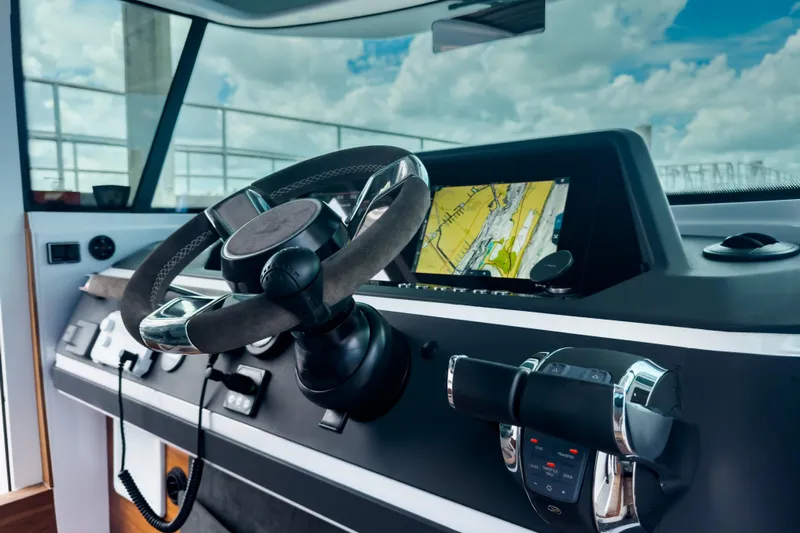  Yacht Photos Pics 2022 Axopar 28 Cabin BRABUS Trim dashboard with steering wheel and navigation display.