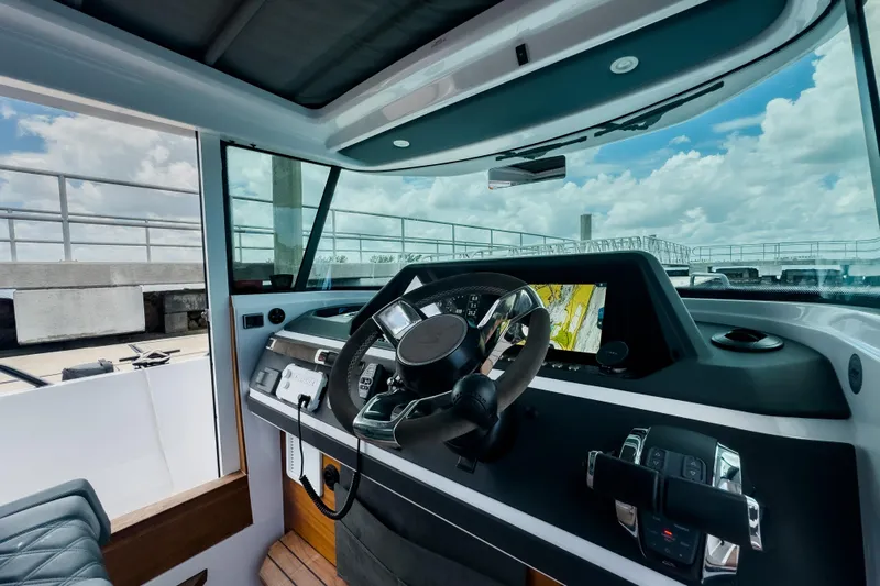  Yacht Photos Pics Interior of 2022 Axopar 28 Cabin BRABUS Trim, featuring modern dashboard and steering wheel.