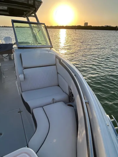  Yacht Photos Pics 2024 Crownline 260DC boat interior with sunset view over the water.