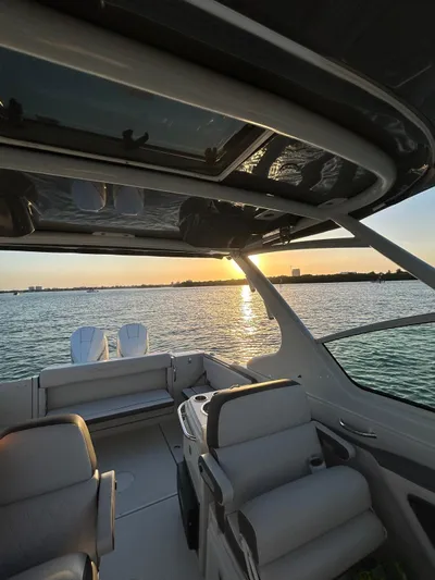  Yacht Photos Pics 2024 Crownline 260DC boat interior with sunset view over the water.