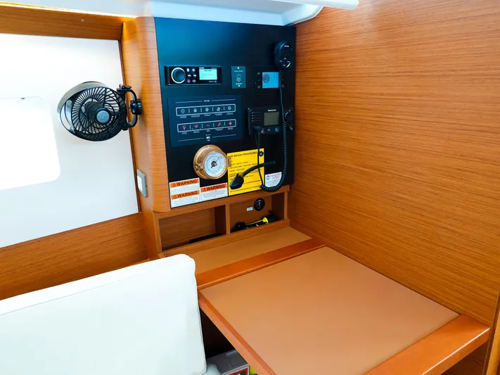 Calypso Express Yacht Photos Pics 2024 Jeanneau Sun Odyssey 380 interior with control panel and wooden finish.