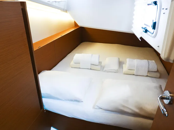 Calypso Express Yacht Photos Pics Cozy cabin interior of 2024 Jeanneau Sun Odyssey 380 with neatly arranged bedding.