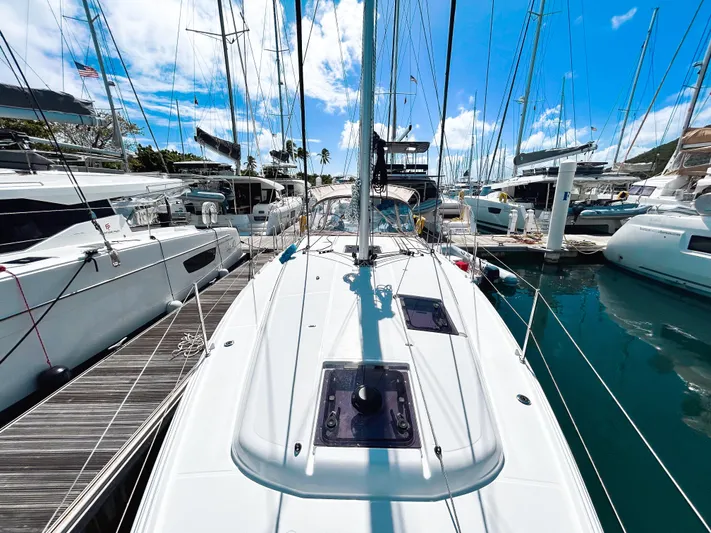 Calypso Express Yacht Photos Pics 2024 Jeanneau Sun Odyssey 380 sailboat docked in a marina under a clear blue sky.