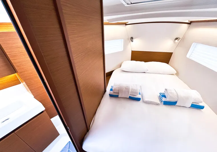 Calypso Express Yacht Photos Pics Luxurious cabin interior of 2024 Jeanneau Sun Odyssey 380 yacht with cozy bed.