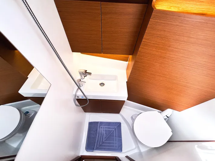 Calypso Express Yacht Photos Pics 2024 Jeanneau Sun Odyssey 380 bathroom with modern fixtures and wooden cabinetry.